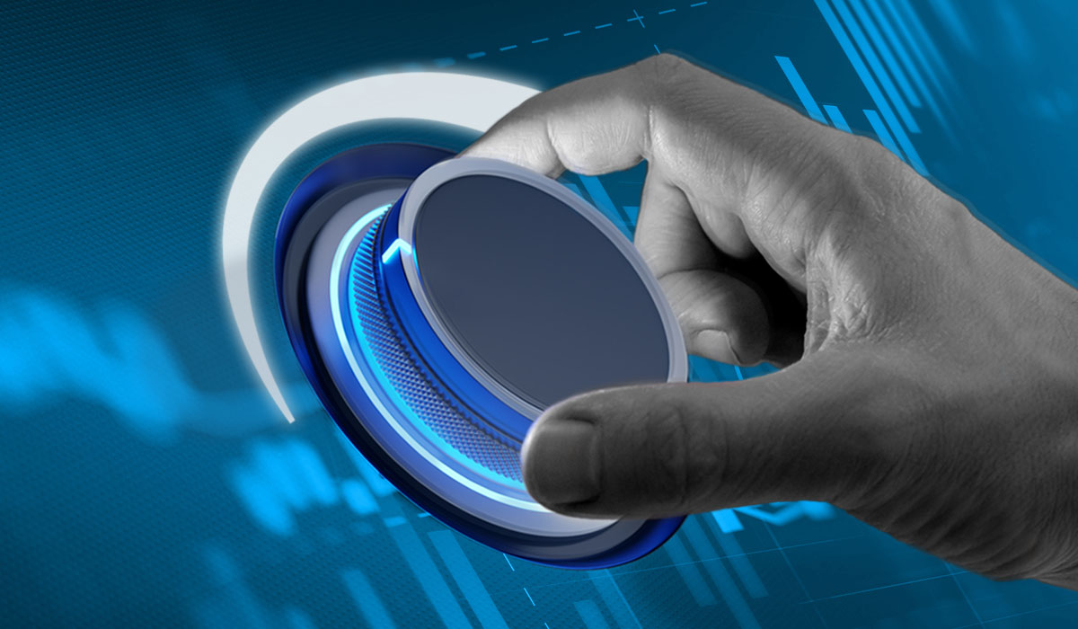 Hand turning a knob adjusting charts representing augmented analytics